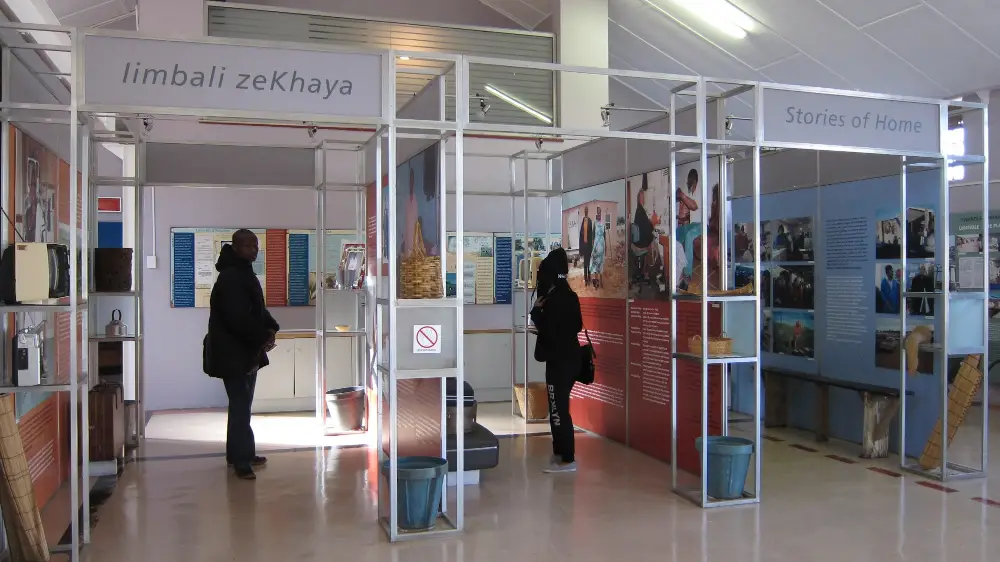 Plate 8. Metal-framed exhibition area with two visitors looking at the display.